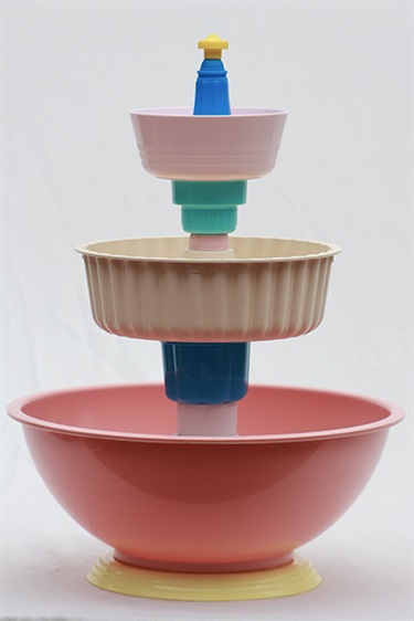 Matthew de Moiser, Fountain No.2, plastic bowls and plate, plastic bottle caps, plastic jelly mould, plastic salt shaker, plastic tube, water fountain pump, silicone, soft drink, 42 x 30 x 30 cm. Appears courtesy of Flinders Street Gallery.