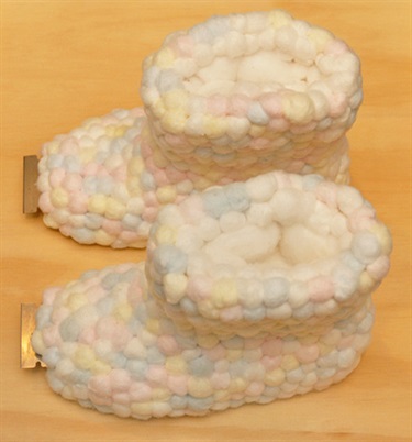 Mary Lou Pavlovic, Family tree-baby, 2003, gumboots, razor blades, cotton wool, 25 x 40 x 30 cm. Courtesy of Niagara Galleries.