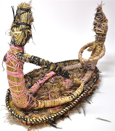 Mary Pan, Wati Minyma Tjungu Pukulpa Ninanyi (Man and Wife Happily Sitting Together), raffia, minarri (grey beard) grass, wool, emu feathers, 56 x 36 x 72 cm. Courtesy of Tjanpi Desert Weavers.