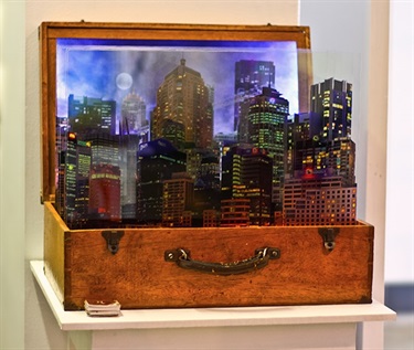 Perran Costi, Portable City, photography, UV prints on glass, suitcase, wood, lights and audio, 65 x 50 x 30 cm.