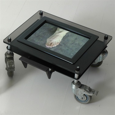 Margaret Seymour, Pas de deux, Perspex, screen, video, steel, castors, 50 x 40 x 25 cm.