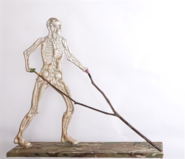 Caroline Rothwell, The Diviner, Britannia metal, thread, DPM camouflage, wood, 60 x 30 x 3 cm. Courtesy of Tolarno Galleries.