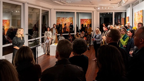 People listening to speeches at the Heart in Art 2023 exhibition